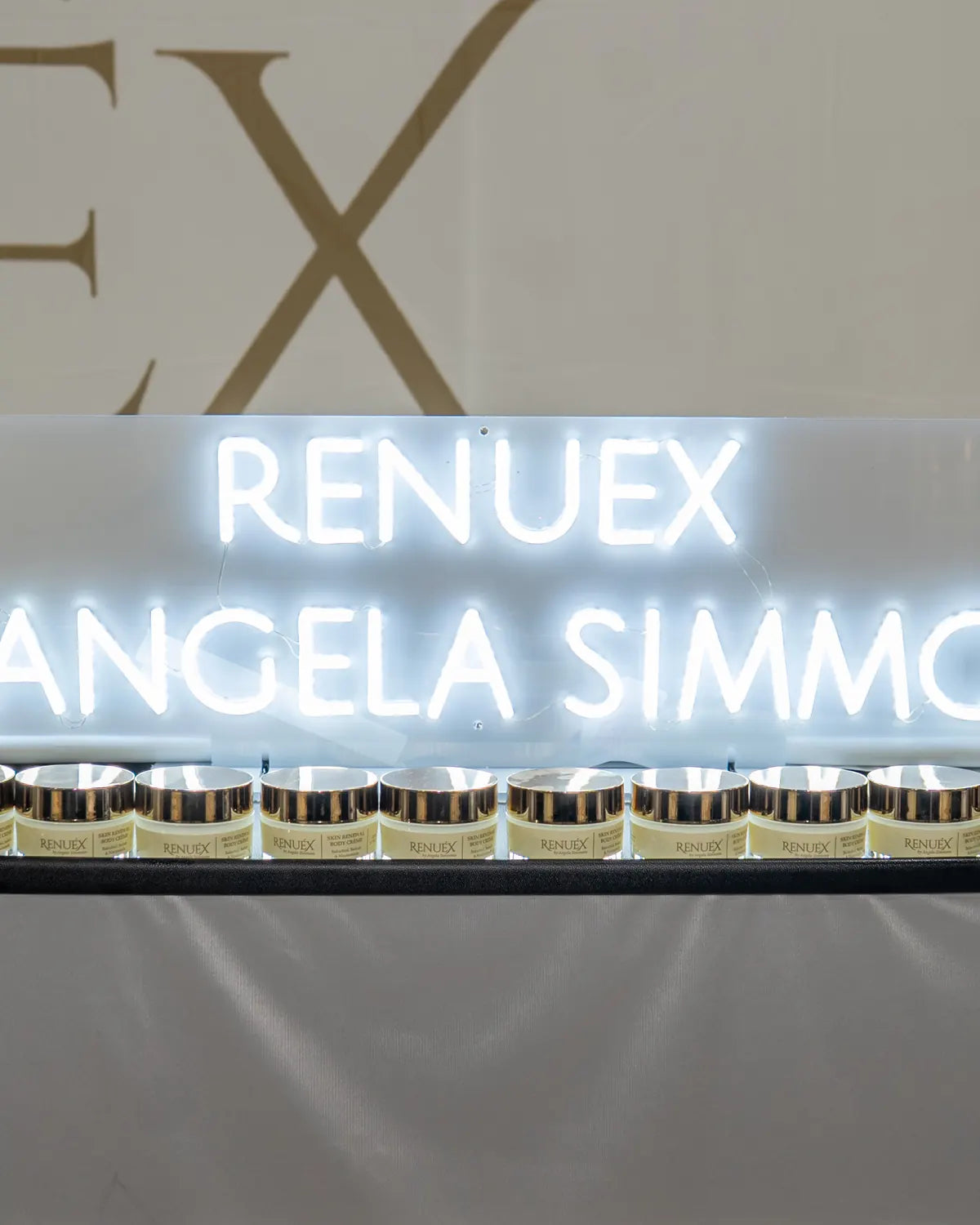 The RENUEX sign above the products at the launch