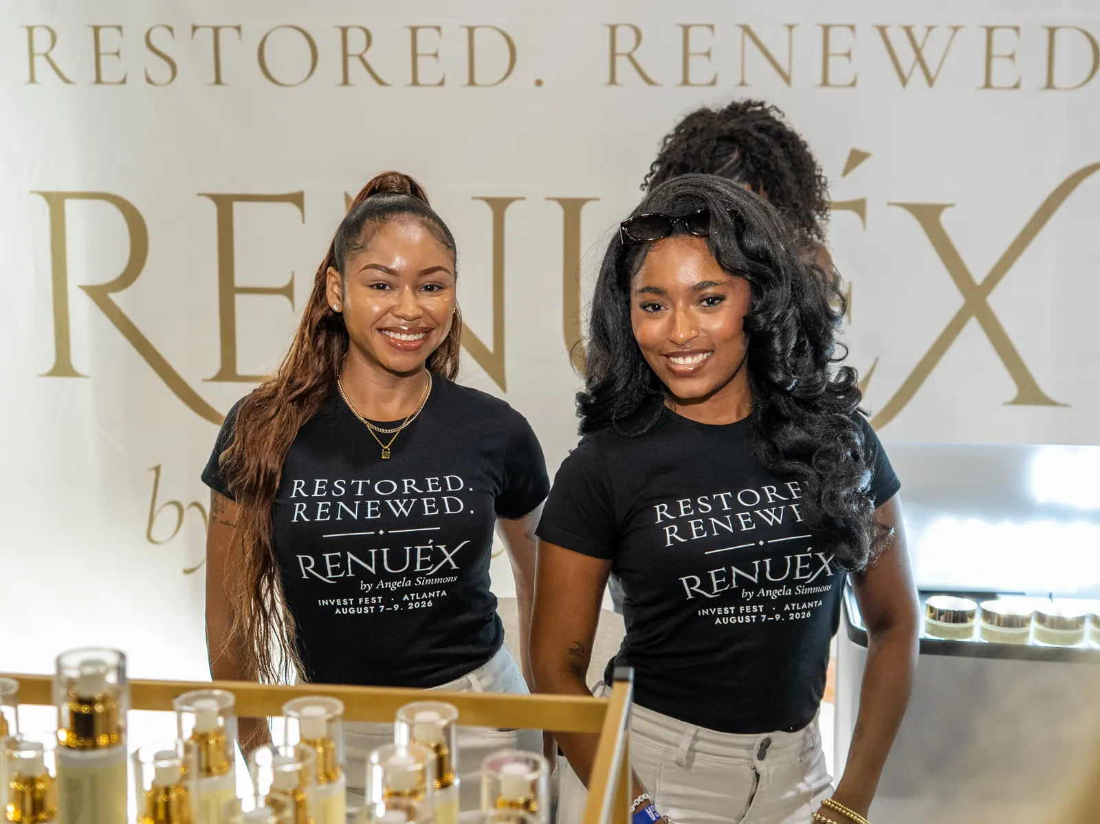 Two of the team in black RESTORED. RENEWED. tees at the booth